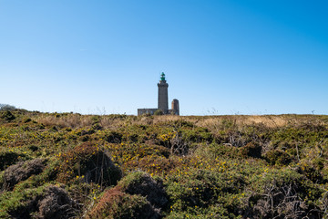 Fototapeta na wymiar ride on the GR34 in Brittany with far off Cape Frehel and its lighthouse