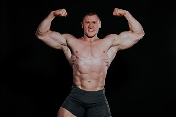 Fototapeta na wymiar Sport the athlete bodybuilder shows off his muscles