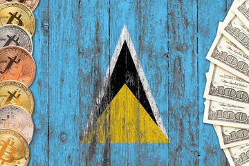Saint Lucia savings concept. Bitcoins and dollar banknotes on the side of national flag with wooden background. Trading currencies.