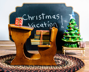 Christmas vacation still life of wood school desk and chalk board
