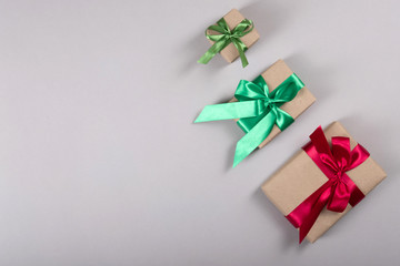 Beautiful packing of presents with satin ribbons and simple paper.