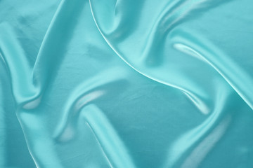 beautiful turquoise silk fabric draped with small folds, soft flowing, luxury concept, wedding,...
