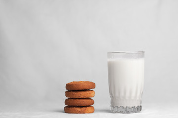 cookies and glass of milk on white background