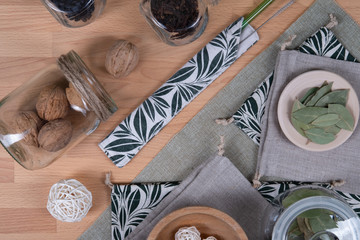 Beautiful composition of reusable objects such as glass tube, linen baggies, wooden dishes and glass jars for everyday life.