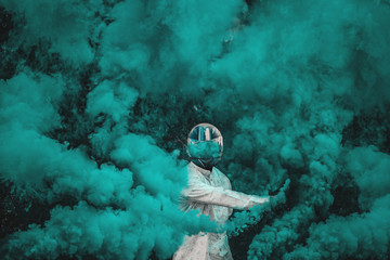 guy in mask standing in between blue smoke bombs - Powered by Adobe