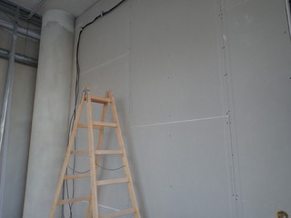  building site with plasterboards and a ladder