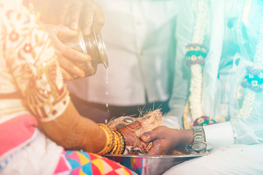 South Indian Bride And Groom Holding Coconut. Milk Pouring Ritual