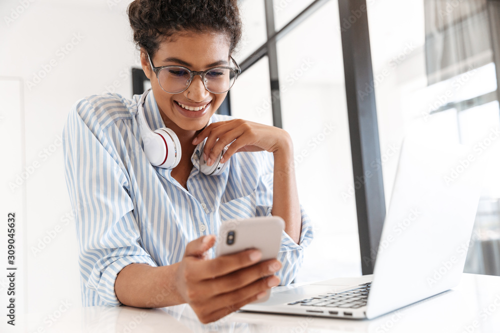 Poster attractive young african woman working on laptop computer