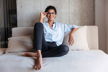 Smiling attractive young african woman wearing shirt relaxing