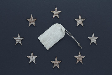 Christmas composition. Wood stars tag on blue background top view background with copy space for your text. Flat lay.