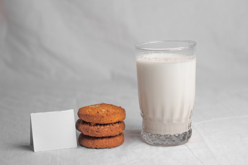 cookies and glass of milk on white background