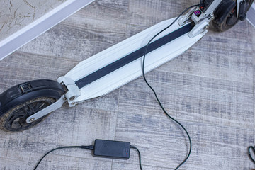 charging the electric scooter battery at home.