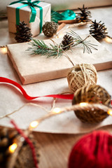 gift wrapping for a book or laptop in craft paper tied with twine rope and decorated with a fir branch with a cone