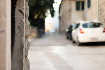 Out of focus small narrow old street in split,croatia. Roman styled ancient houses with modern cars...