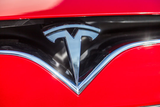 FUERTH / GERMANY - MARCH 4, 2018: Tesla logo on a Tesla car Tesla, Inc. is an American company that specializes in electric automotives, energy storage and solar panel manufacturing.