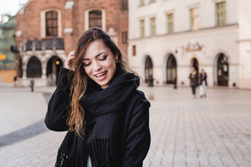 Portrait of stylish smiling happy woman walking in street, positive mood, girl enjoy weekends