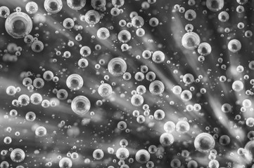 Oxygen Bubbles in Liquid. Rays. Black and white