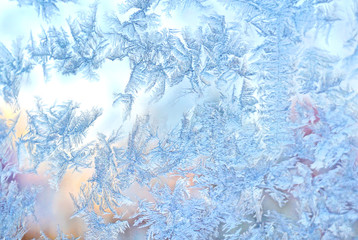 Ice flowers frozen blue window textured background