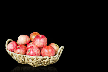 Ripe red apples, in a wicker basket