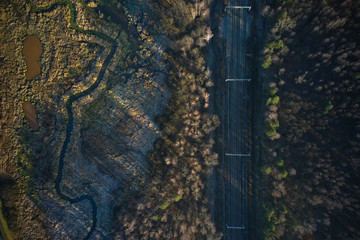 Aerial shot of rail tracks and swamp 
