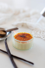 Torching a creme brûlée in white kitchen