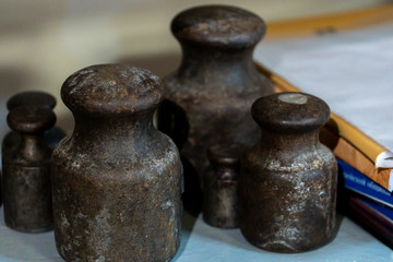 old metal weights for mechanical scales. Rusty metal from the past. Measuring instrument for a...