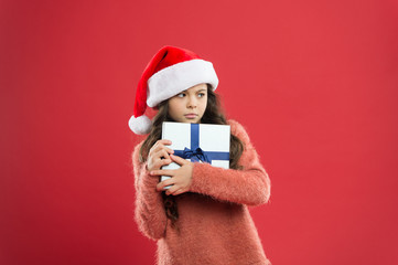 only mine. kid shopping sales. xmas boxing day. best christmas offer. little girl hold present box. happy new year gift. christmas holiday party. small girl in santa hat. greedy child red wall.
