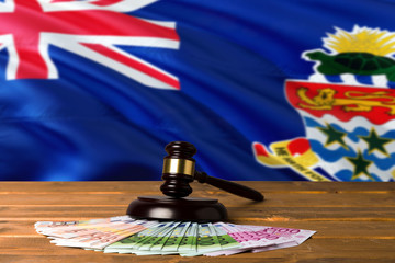 Cayman Islands bribing concept. Law theme, mallet of the judge on wooden desk with national flag...