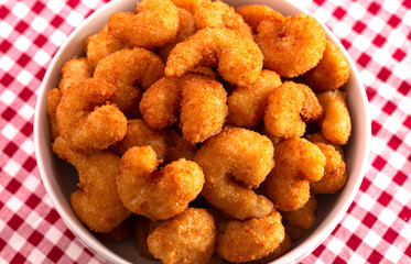A Bowl of Popcorn Shrimp on a Red Gingham Table Cloth