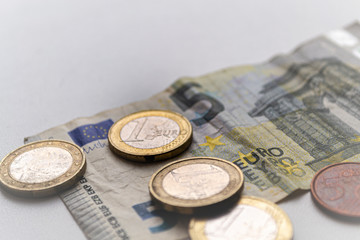 Several euro coins on light blurred background. Closeup photo