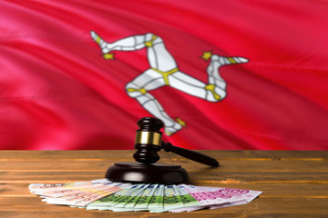 Isle Of Man bribing concept. Law theme, mallet of the judge on wooden desk with national flag...