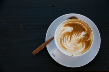 Fresh cappuccino isolated on black table