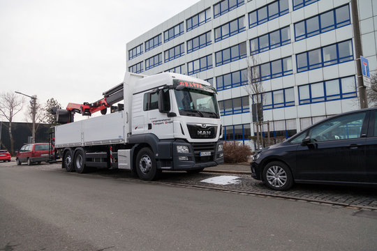 NUERNBERG / GERMANY - MARCH 4, 2018: MAN flatbed truck with crane stands on roadside in a industrial district.