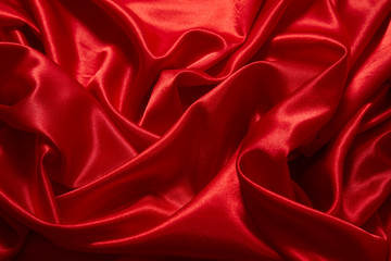Obraz premium Luxury red satin smooth fabric background for celebration, ceremony, event invitation card or advertising poster