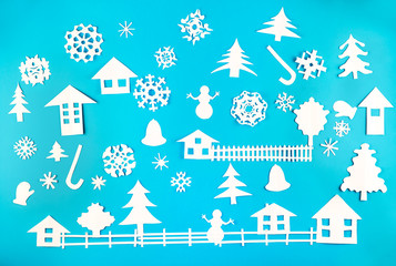 Fototapeta na wymiar Christmas theme figures made of white paper on blue background
