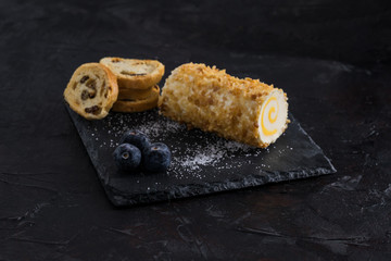 Gastronomic dish consisting of pineapple cheese accompanied by blueberries and bread with raisins. Food concept.