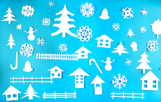 Christmas theme figures made of white paper on blue background © gorvik