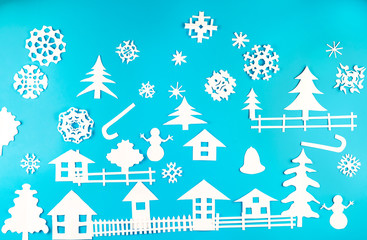 Obraz na płótnie Canvas Christmas theme figures made of white paper on blue background