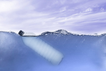the simple single plastic bottle in ocean water underwater, environment problems and pollution