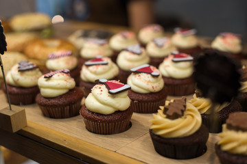 Shop window with vanilla cupcakes, bakery store. Food concept