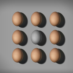 Top view of brown eggs and gray egg in center. Colorless egg between brown colored eggs.
