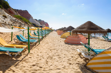 Sunbeds and umbrellas on Falesia Beach