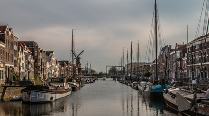 Fototapeta premium View from the Piet Heynsbridge to the Aelbrechtskolk of the historic Delfshaven and the Windmill 