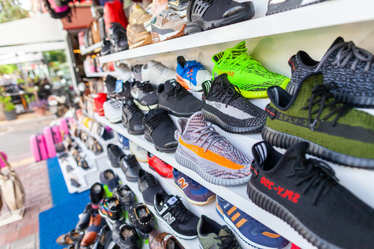 ALANYA / TURKEY - SEPTEMBER 30, 2018: Shoes of different brands stands in a shop in Alanya