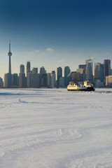 Wards Island Ferry returning to downtown Toronto over snow and ice covered Lake Ontario