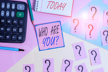 Word writing text Who Are You Question. Business photo showcasing asking about someone identity or demonstratingal information Mathematics stuff and writing equipment above pastel colours background