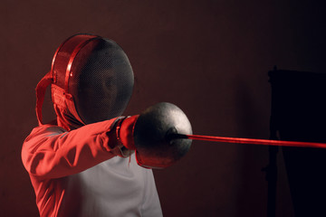 Fencer woman with fencing sword.