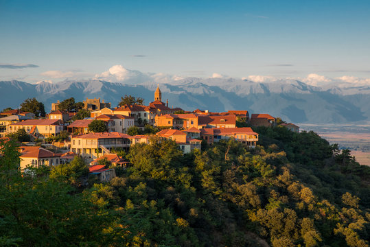 Panoramic view of Sighnaghi in winery region of Georgia, Kakheti, during sunset in summer with Caucasus mountains in the background