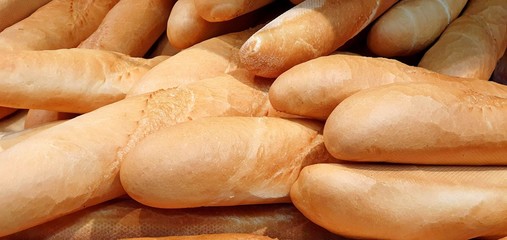 Fresh fragrant baguettes on a shelf in a supermarket, concept of delicious food