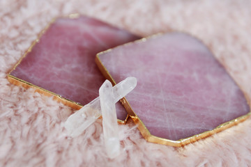 Rose quartz coasters with two small crystals. Mystical altar on pink background. 